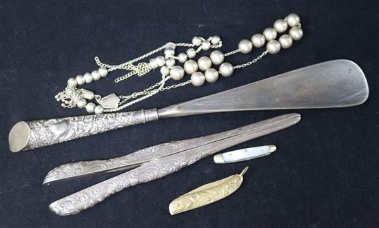 A silver handled shoe horn, silver glove stretchers, beads, etc.